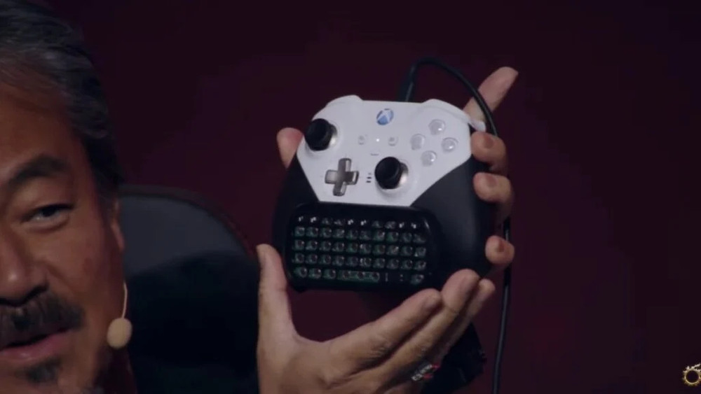 Hironobu Sakaguchi shows the Xbox controller he uses to play Final Fantasy XIV