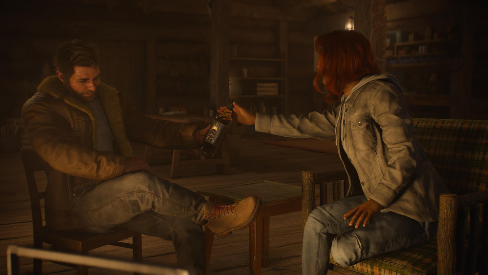 Jean y Logan bebiendo whisky en la cabaña del héroe en Canadá