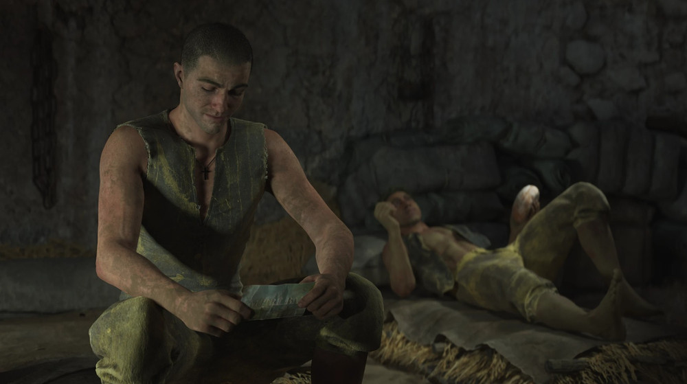 The main character, Enzo, sitting in his dorm room with a photo in his hand